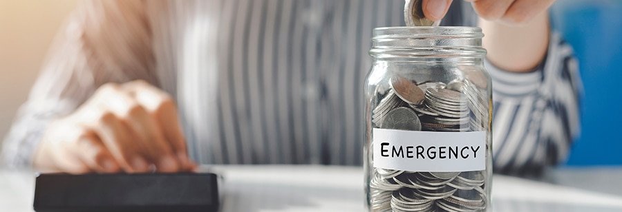 woman putting money in an emergency fund