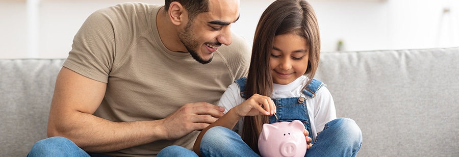 dad and daughter saving money