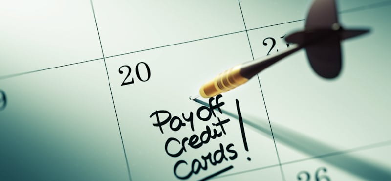 pay off credit cards written on whiteboard